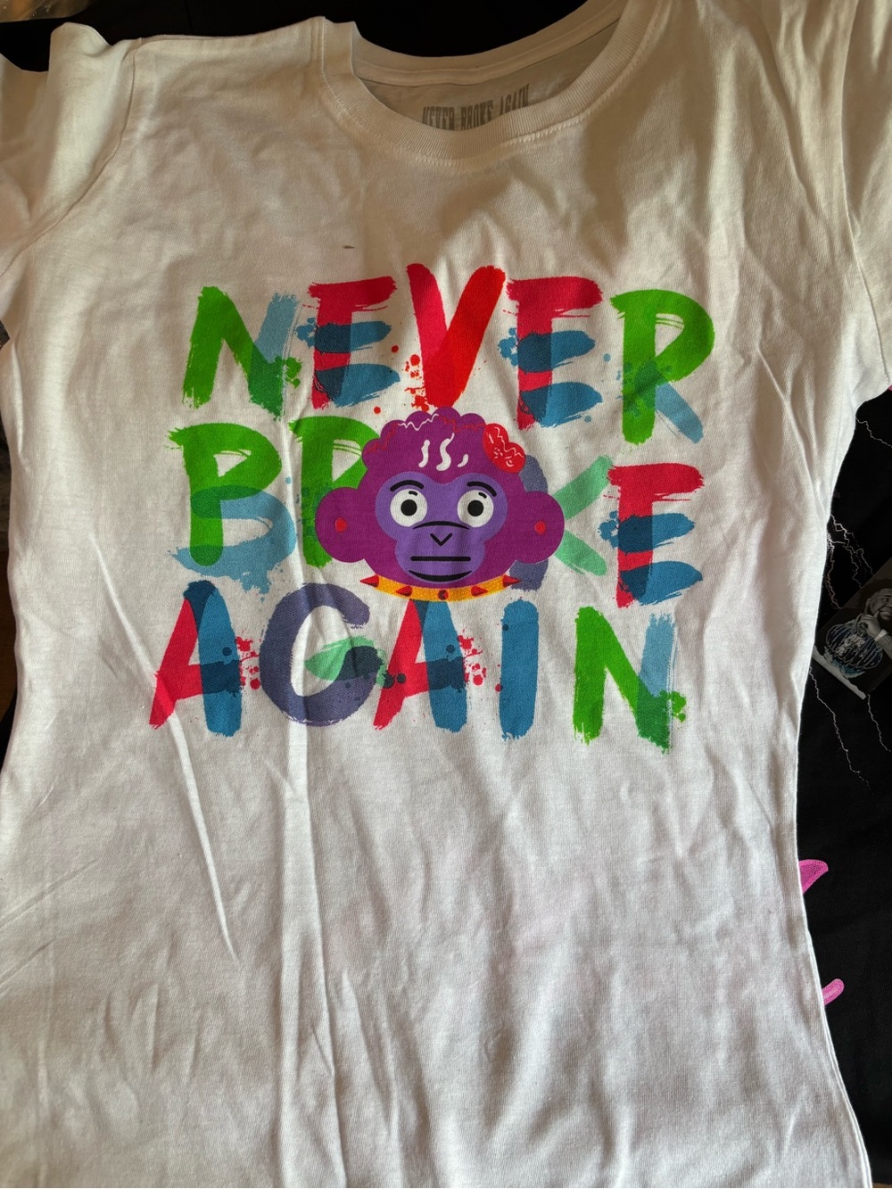 White Graphic Tee with Colorful 'Never Break Again' Print